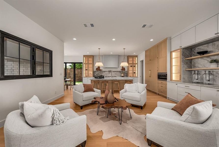 Living room with light wood-type flooring and recessed lighting Living room with light wood-type flooring and recessed lighting