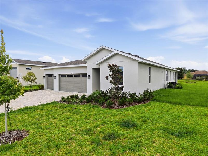 Front exterior of a new home in Glen Lakes, Weeki Wachee, FL, highlighting curb appeal (Image 20).