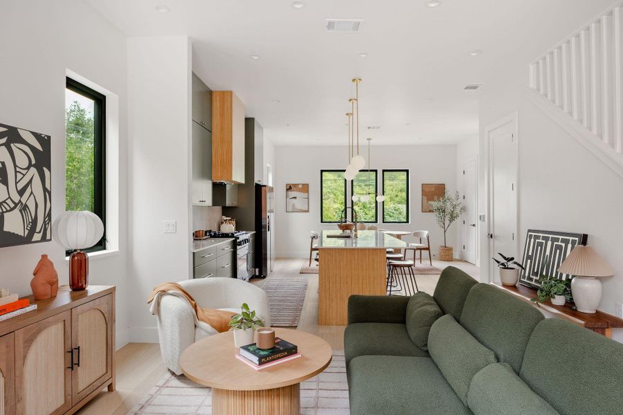 Living area featuring light wood-style floors, stairway, and recessed lighting Living area featuring light wood-style floors, stairway, and recessed lighting
