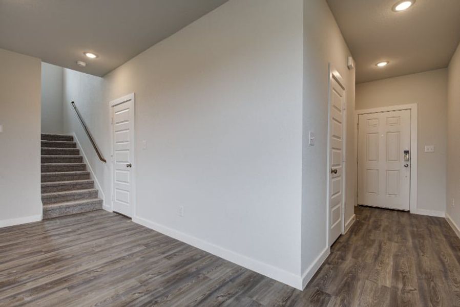 A hallway with white doors. A hallway with white doors.