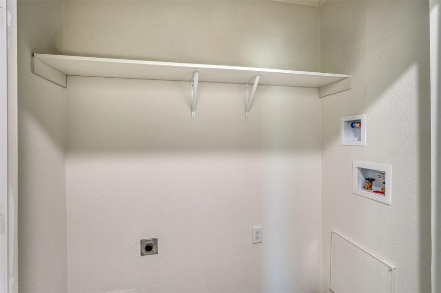 Functional utility space, complete with convenient shelving and hookups, ready for laundry appliances. Functional utility space, complete with convenient shelving and hookups, ready for laundry appliances.