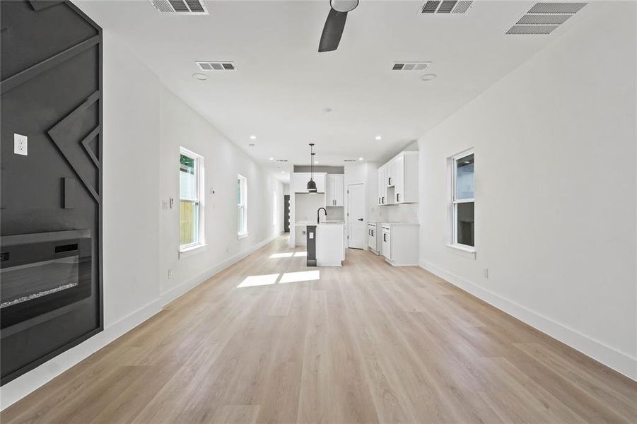 Unfurnished living room with recessed lighting, light wood-type flooring, and ceiling fan