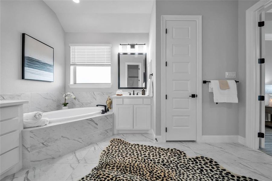Full bathroom with light marble finish flooring, vanity, a garden tub, and recessed lighting Full bathroom with light marble finish flooring, vanity, a garden tub, and recessed lighting