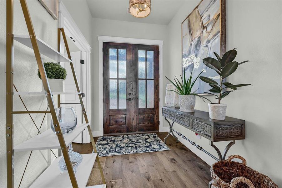 Entryway with french doors and wood-type flooring