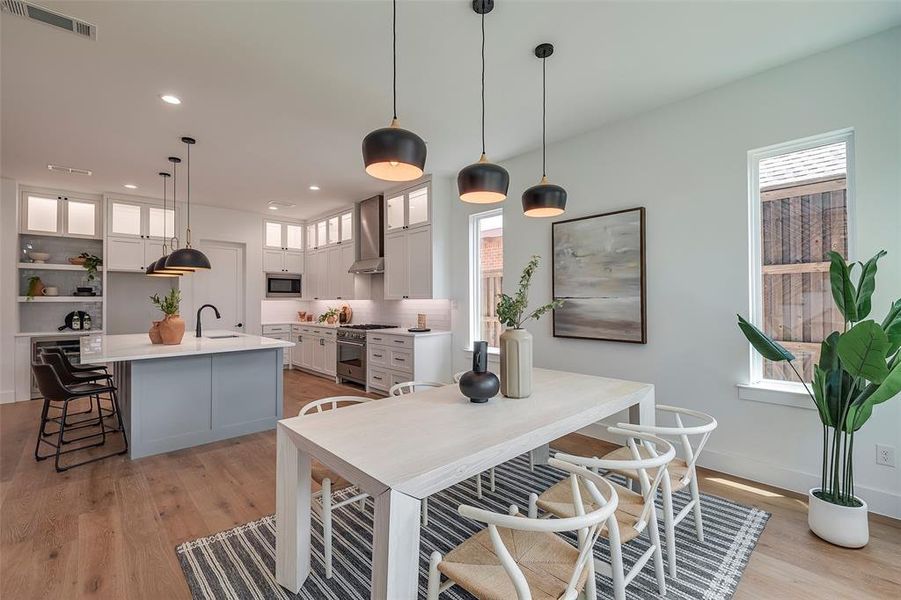 Dining room featuring sink and light wood-type flooring