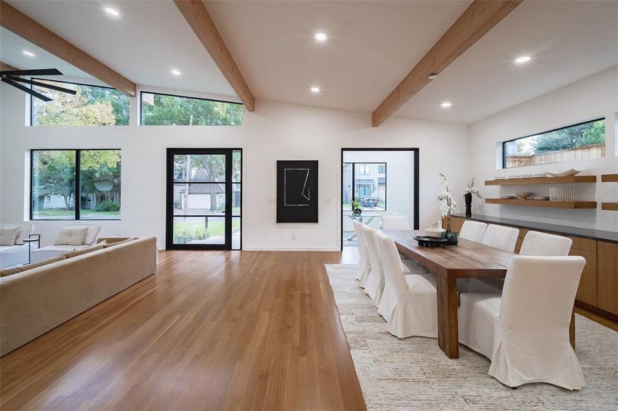 Dining room featuring plenty of natural light, light hardwood / wood-style floors, beam ceiling, and ceiling fan