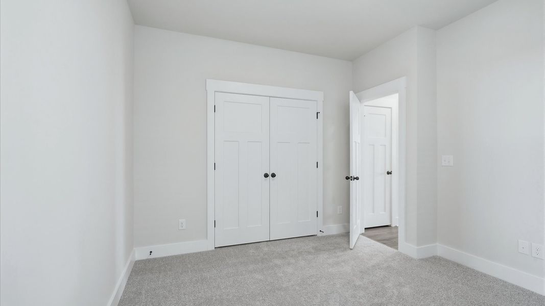 First-rate secondary bedroom with a spacious walk-in closet and elegant carpeted flooring in Spartanburg, SC