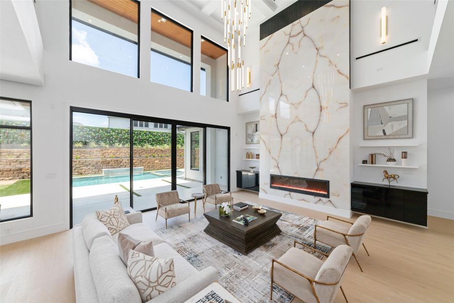 The heart of the home opens before you with soaring ceilings and walls of glass.