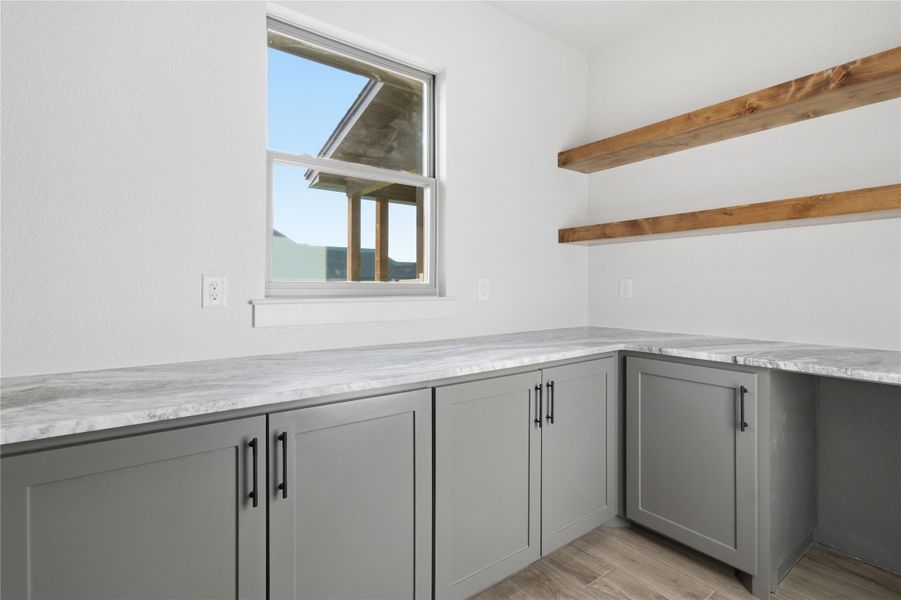 Functional workspace with robust countertops and ample cabinetry provides storage and utility. Functional workspace with robust countertops and ample cabinetry provides storage and utility.