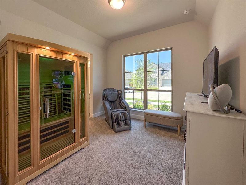 Living area featuring vaulted ceiling and light carpet Living area featuring vaulted ceiling and light carpet