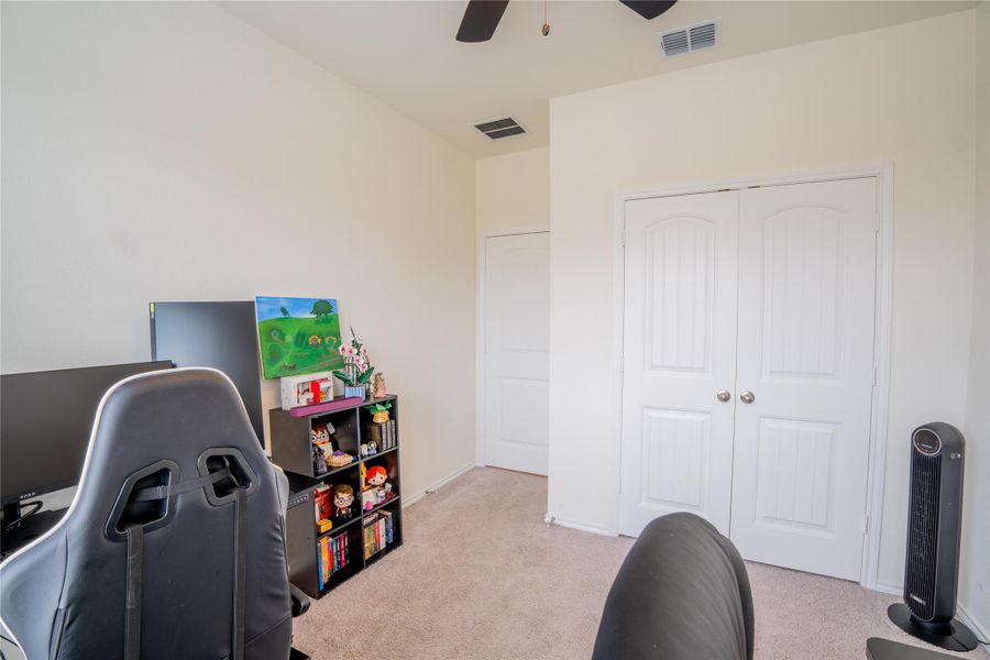 Carpeted room featuring light-colored walls and a ceiling fan Carpeted room featuring light-colored walls and a ceiling fan