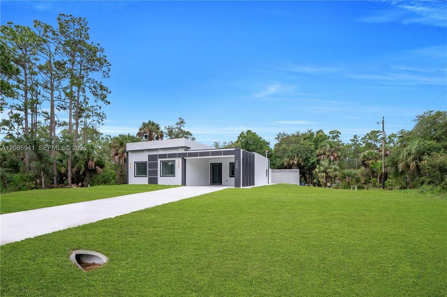 Front exterior of a new home in , Lehigh Acres, FL, highlighting curb appeal (Image 2). Front exterior of a new home in , Lehigh Acres, FL, highlighting curb appeal (Image 2).