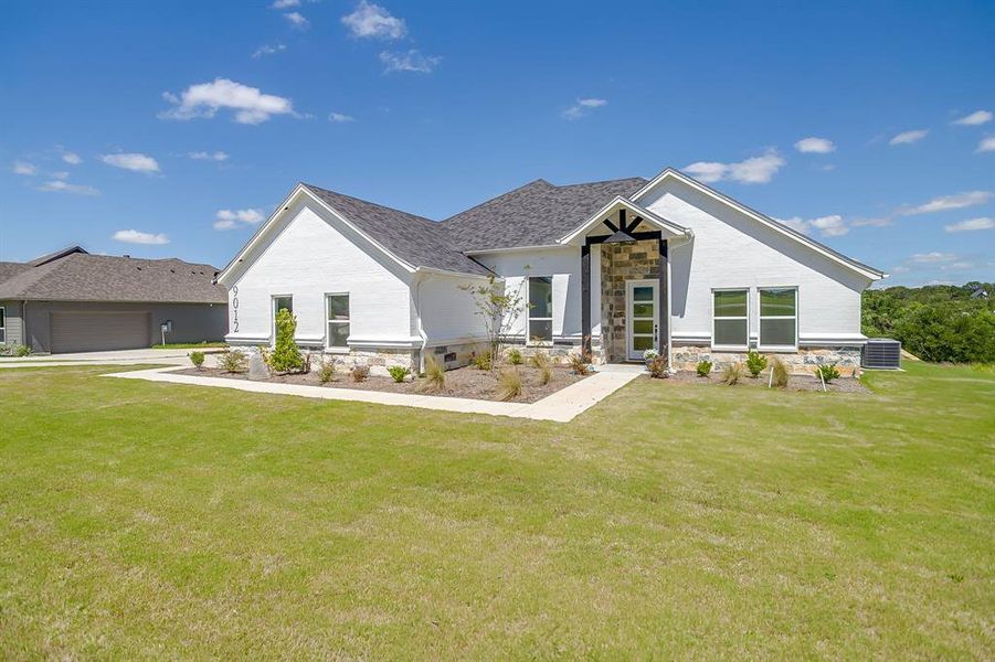 Front exterior of a new home in , Springtown, TX, highlighting curb appeal (Image 27). Front exterior of a new home in , Springtown, TX, highlighting curb appeal (Image 27).