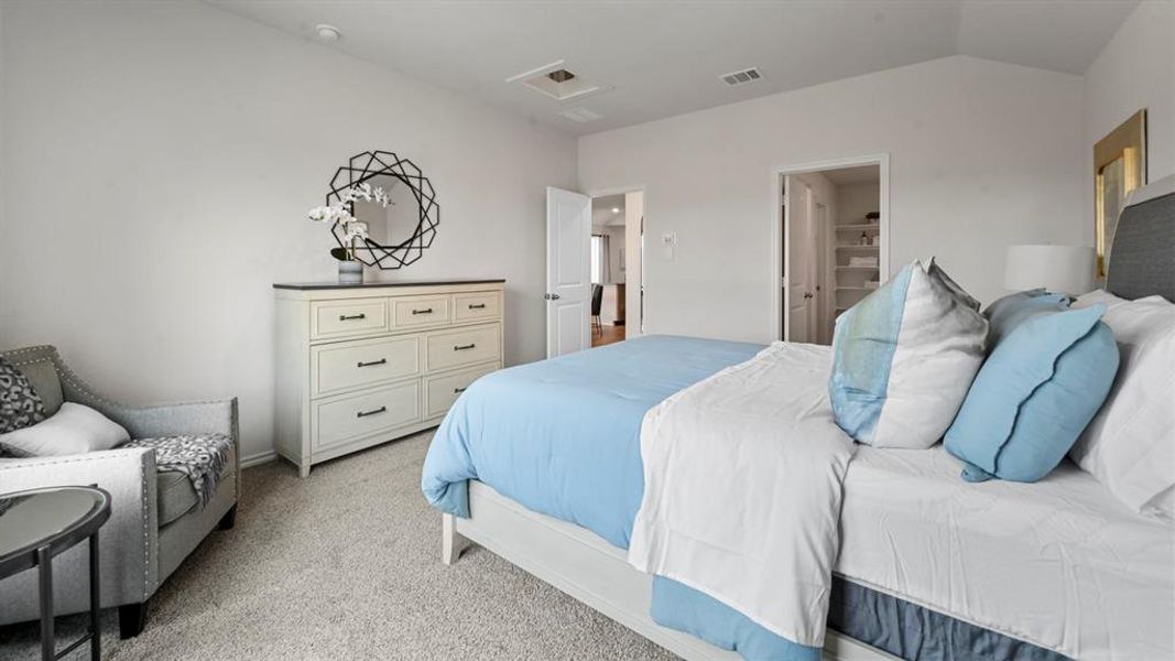 Bedroom with light carpet, attic access, and vaulted ceiling Bedroom with light carpet, attic access, and vaulted ceiling