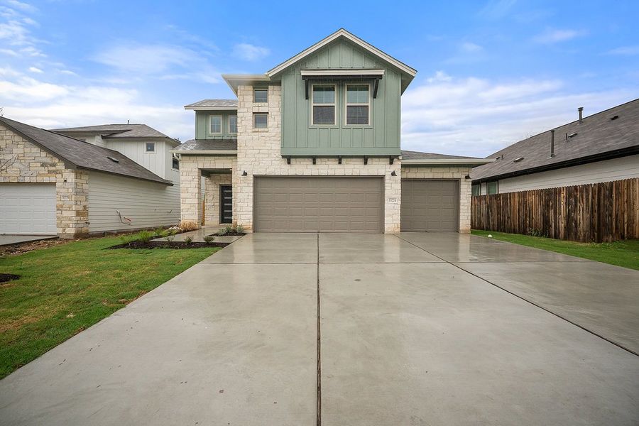 Front exterior of a new home in The Hills of Bear Creek, Manchaca, TX, highlighting curb appeal (Image 3). Front exterior of a new home in The Hills of Bear Creek, Manchaca, TX, highlighting curb appeal (Image 3).