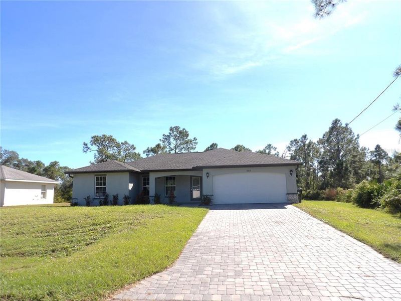 Front exterior of a new home in , North Port, FL, highlighting curb appeal (Image 1). Front exterior of a new home in , North Port, FL, highlighting curb appeal (Image 1).