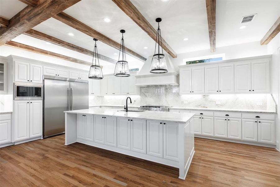 Kitchen with quartzite counter tops and matching quartzite back splash