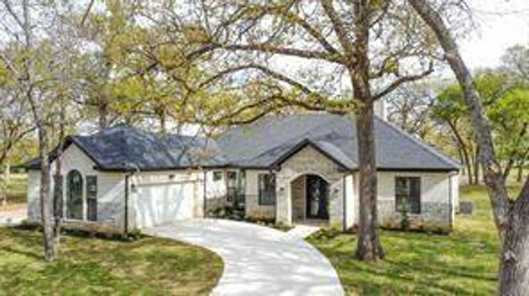 View of front of home featuring a garage and a front lawn