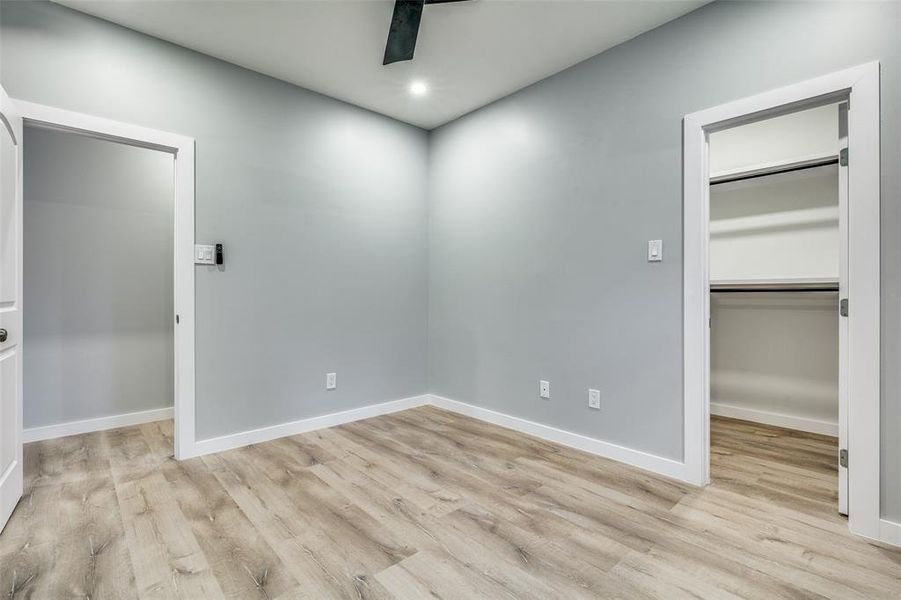 Unfurnished bedroom featuring ceiling fan, a closet, and light hardwood / wood-style floors