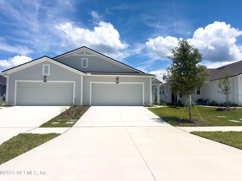 Front exterior of a new home in RiverTown - WaterSong, St. Johns, FL, highlighting curb appeal (Image 28). Front exterior of a new home in RiverTown - WaterSong, St. Johns, FL, highlighting curb appeal (Image 28).