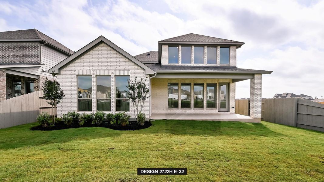 Rear view of house with a patio, brick siding, and roof with shingles