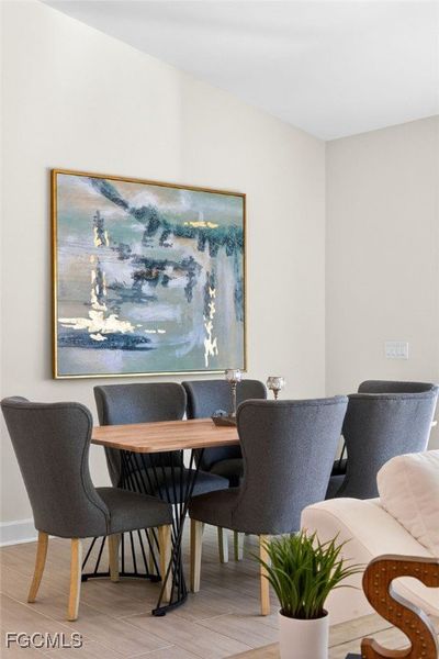 Dining room with wood finished floors and baseboards