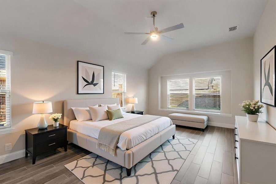 Bedroom with wood finished floors, ceiling fan, and vaulted ceiling