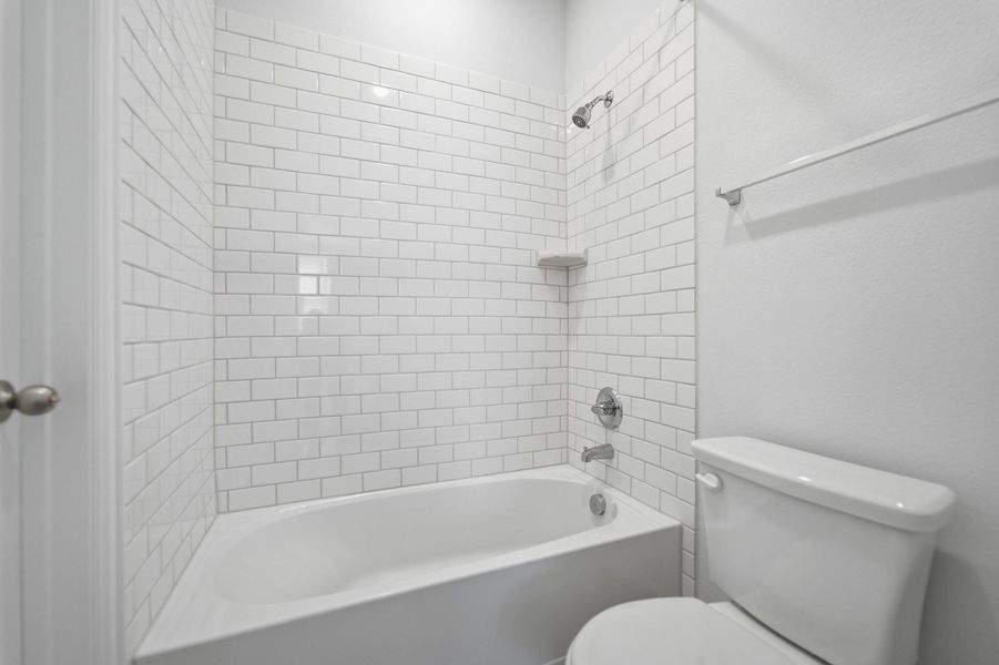 Bathroom with toilet and bathing tub / shower combination