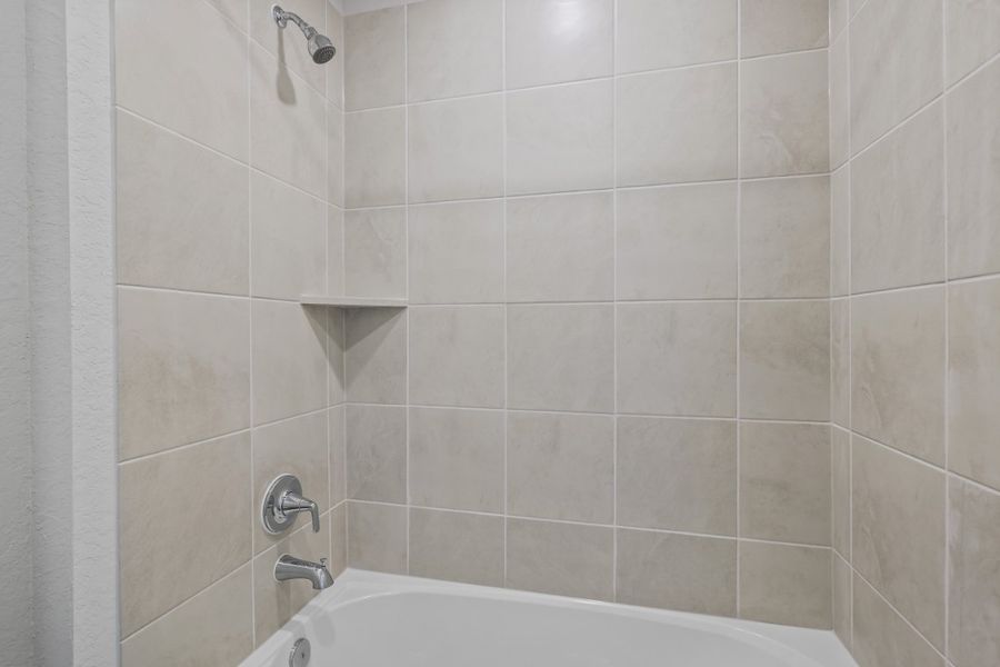 A bathtub and a shower unit.