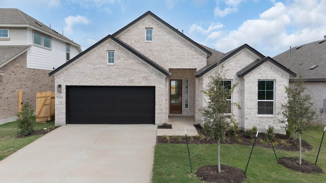 Front exterior of a new home in The Grove at Blackhawk, Pflugerville, TX, highlighting curb appeal (Image 27). Front exterior of a new home in The Grove at Blackhawk, Pflugerville, TX, highlighting curb appeal (Image 27).
