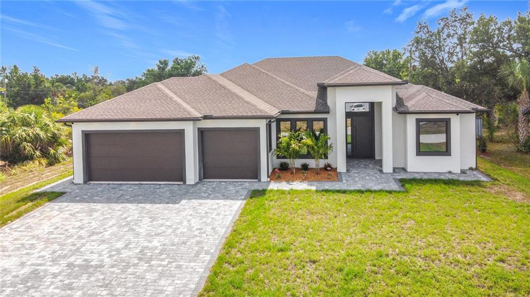 Front exterior of a new home in , Englewood, FL, highlighting curb appeal (Image 1). Front exterior of a new home in , Englewood, FL, highlighting curb appeal (Image 1).