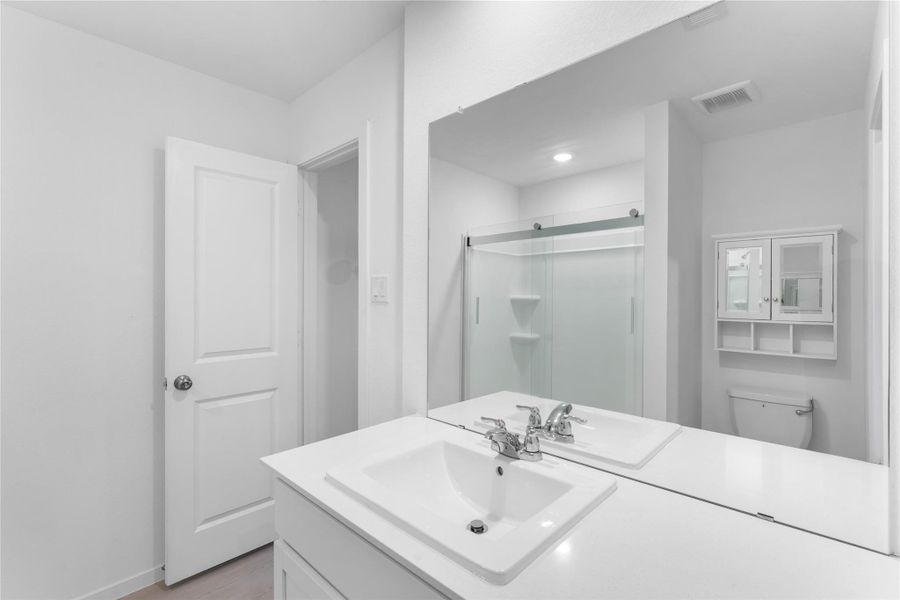 Generous countertop space and a functional vanity provide plenty of room for everyday essentials.