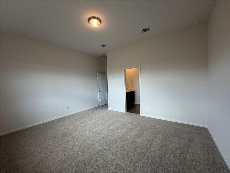 Unfurnished bedroom with carpet flooring and ensuite bath