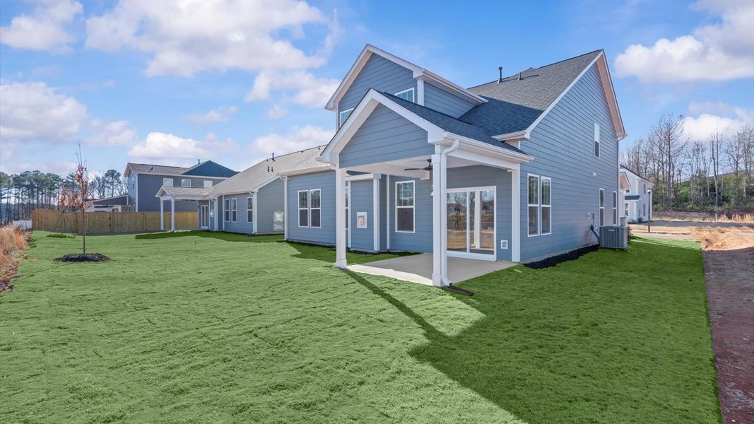 Exceptional outdoor living begins with a covered back porch in this thoughtfully designed home