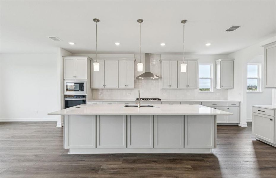 Bright kitchen with an expansive center island perfect for gatherings  *Real home pictured