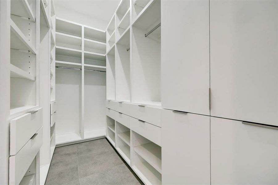 Two walk in closets with custom built ins