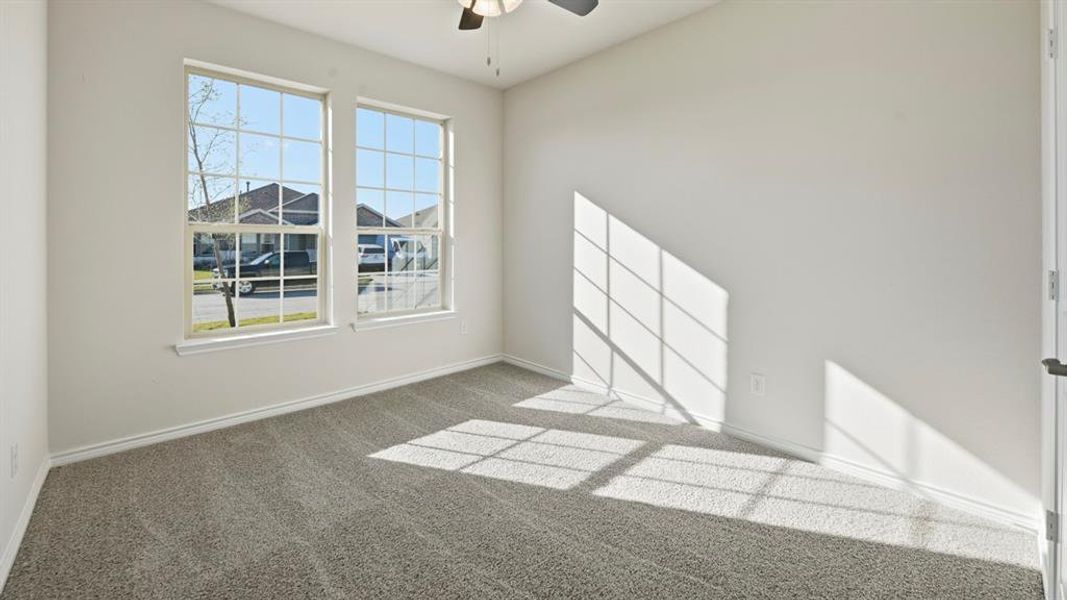 Empty room with carpet floors and a ceiling fan