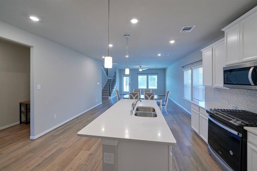 Kitchen adjacent to dining and living room.