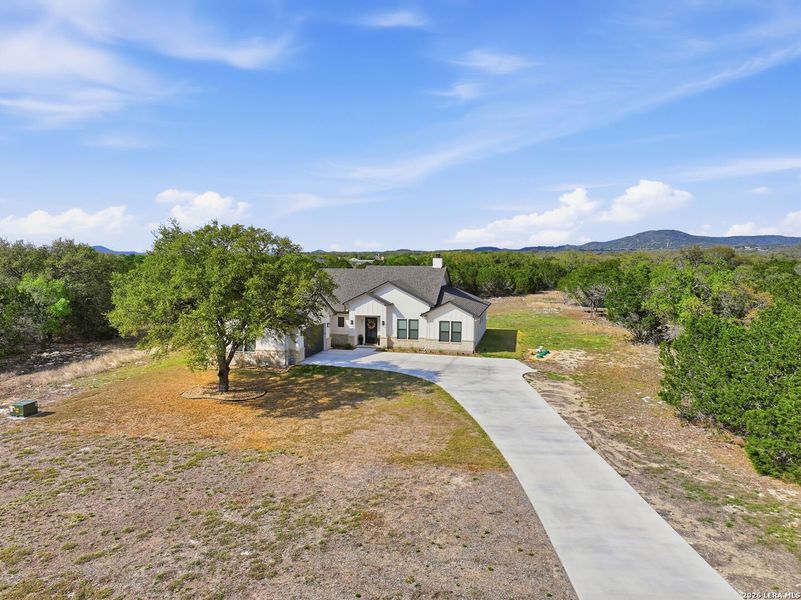 Front exterior of a new home in , Bandera, TX, highlighting curb appeal (Image 22).