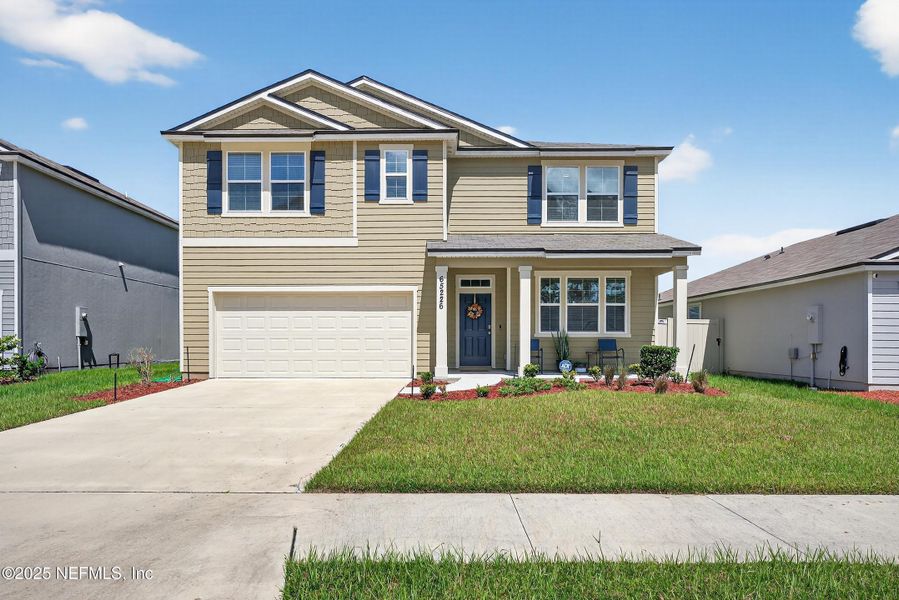 Front exterior of a new home in River Glen Express, Yulee, FL, highlighting curb appeal (Image 22).