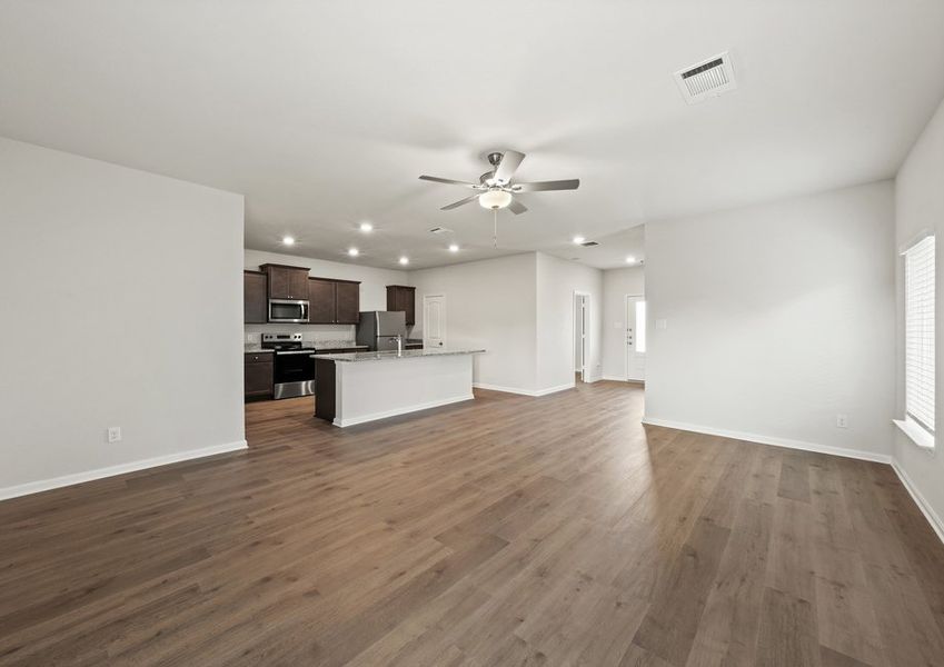 The kitchen sits adjacent to the dining room and living room. The kitchen sits adjacent to the dining room and living room.
