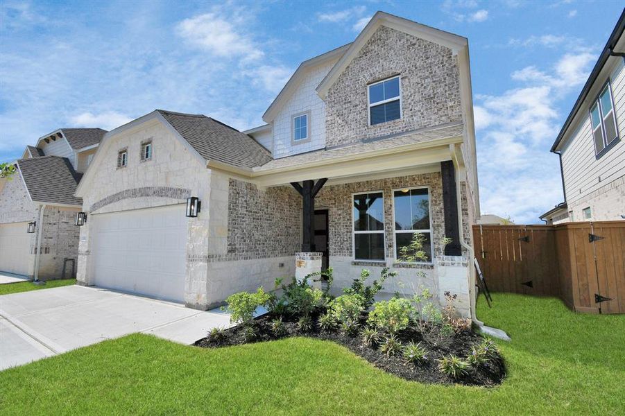 This home boasts lush green grass and meticulous landscaping. Its premium elevation showcases an exquisite blend of brick and stone features, complemented by modern coach lighting