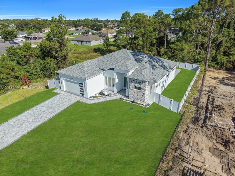 Front exterior of a new home in , Lehigh Acres, FL, highlighting curb appeal (Image 26).