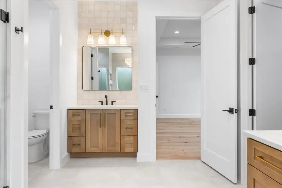 Primary bathroom with second vanity, light tile patterned floors Primary bathroom with second vanity, light tile patterned floors