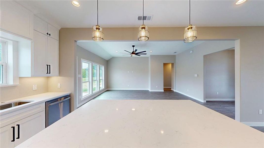 Quartz countertops and huge island with pendant lights