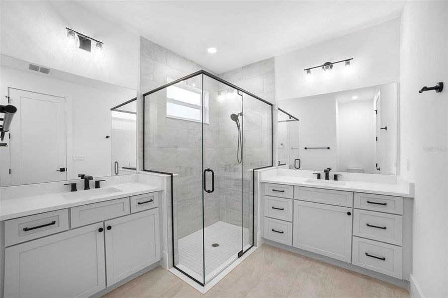 Master Bathroom with dual vanities and custom glass shower enclosure