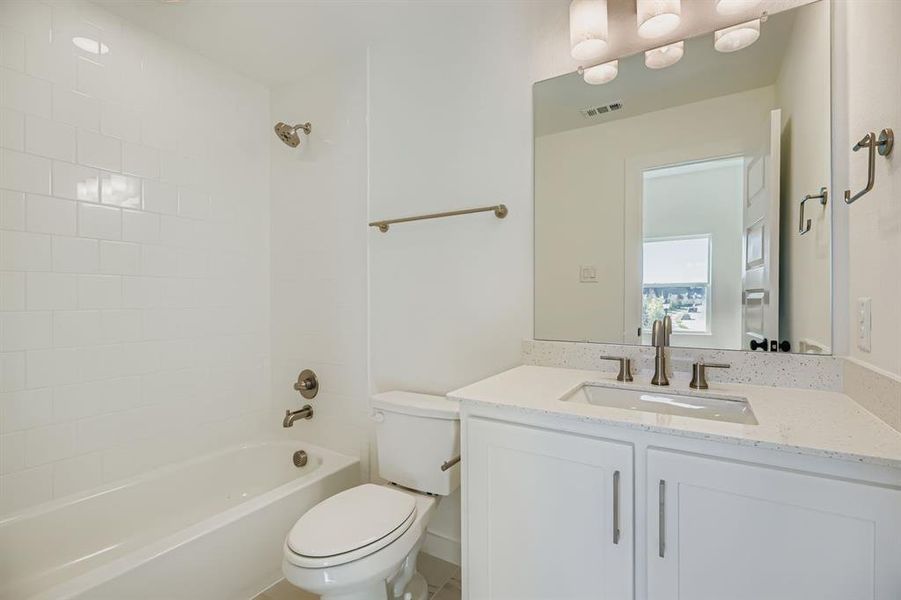 Bathroom featuring tub / shower combination and vanity