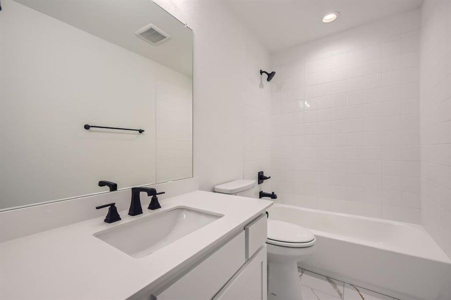 Full bathroom with vanity, marble finish flooring, shower / washtub combination, and recessed lighting Full bathroom with vanity, marble finish flooring, shower / washtub combination, and recessed lighting