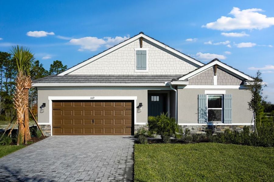 Front exterior of a new home in Hammock at Two Rivers, Zephyrhills, FL, highlighting curb appeal (Image 1). Front exterior of a new home in Hammock at Two Rivers, Zephyrhills, FL, highlighting curb appeal (Image 1).