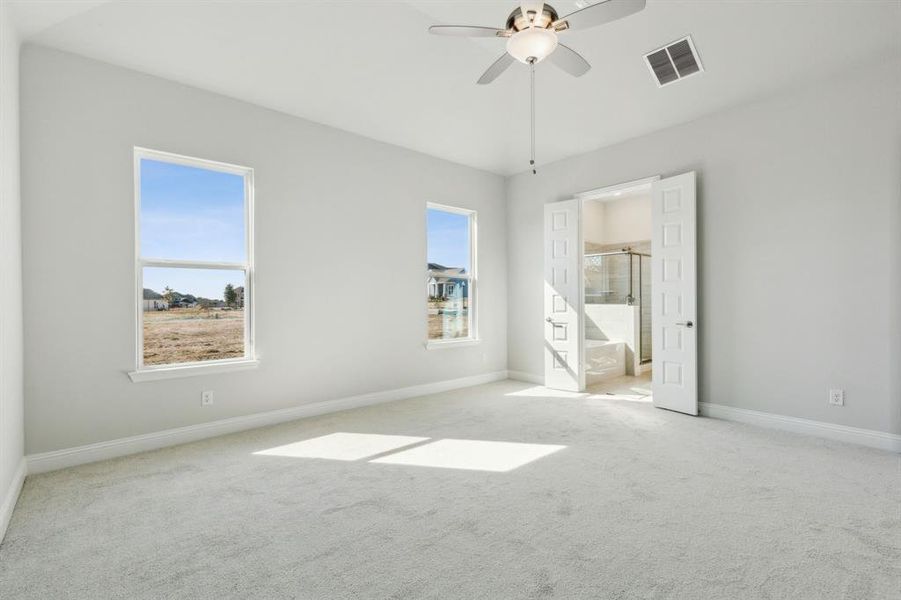 Carpeted empty room with ceiling fan